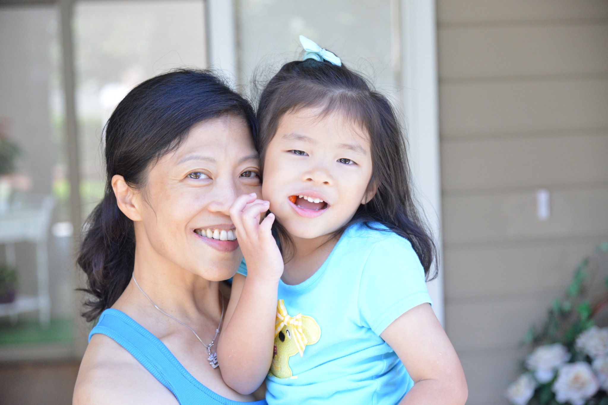 A mother and a young girl smiling together in the founder’s family photographs
